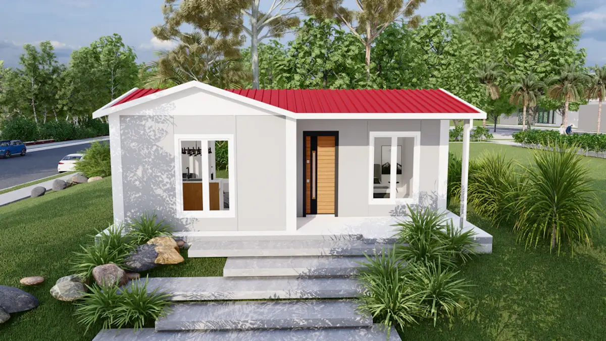 A small, modern prefabricated house with a red roof.